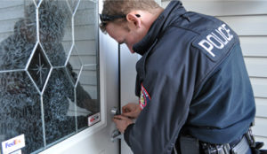 Law enforcement officer picking lock for a covert entry